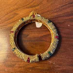 Gold bracelet with colorful gems.